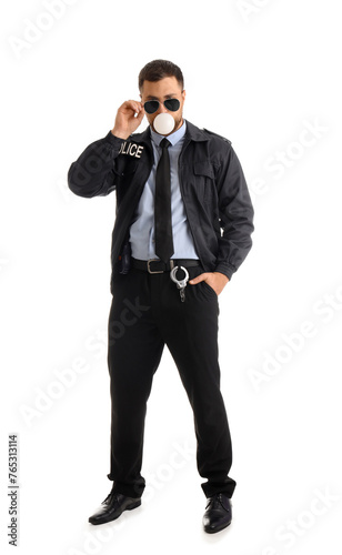 Male police officer blowing bubble gum on white background