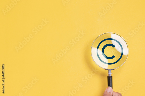 Copyright or patent concept. Magnifying glass focus to copyright symbol for author rights and patented intellectual property. copyleft trademark license.