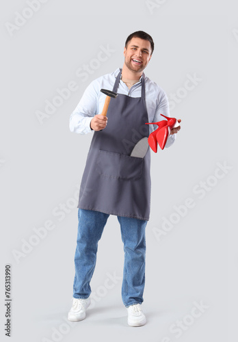 Male shoemaker with hammer ...