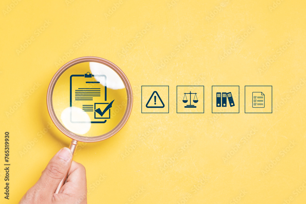 Compliance in business concept. Magnifying glass focus to compliance icon on yellow background, ensuring the enforcement of laws, regulations, and standards. Stay in line with business policies. - obrazy, fototapety, plakaty 