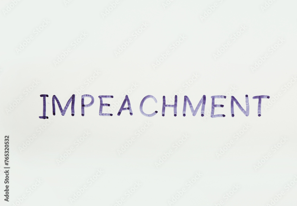 Word IMPEACH written with felt pen on glass against white background
