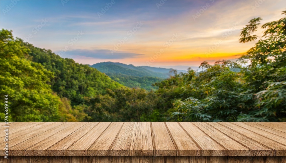 a wooden table top product display with a blurred background scene of tree foliage at sunset