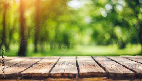 blank wooden table on green summer park background banner