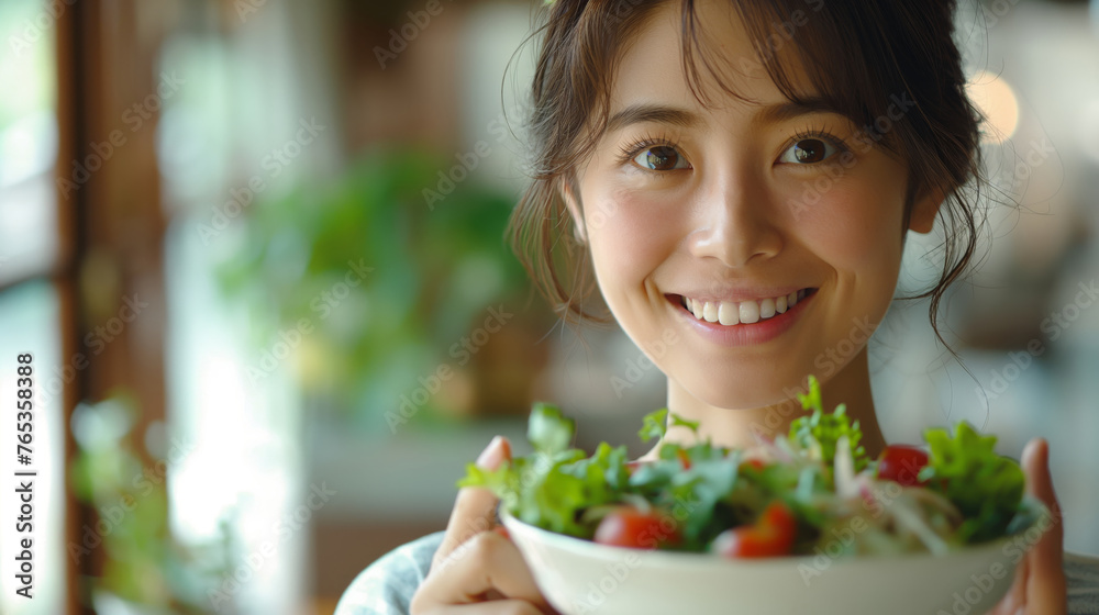 a woman is holding a salad bowl and smiles. healthy eating and diet concept. a woman is holding a salad bowl and smiles. healthy eating and diet concept.