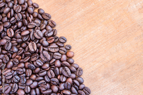 Coffee beans on wooden table background photo