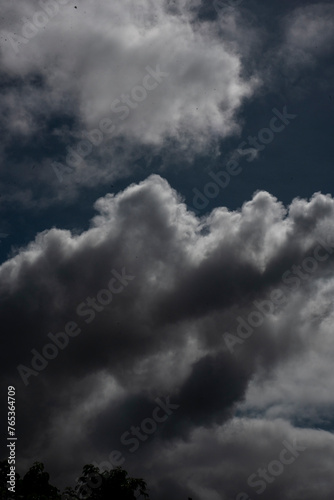 Vertical Dramatic dark storm rain clouds black sky background. Dark thunderstorm clouds rainny atmosphere. windstorm disasters climate. Dust ominous cloudscape storm disaster gloomy gray cloud sky