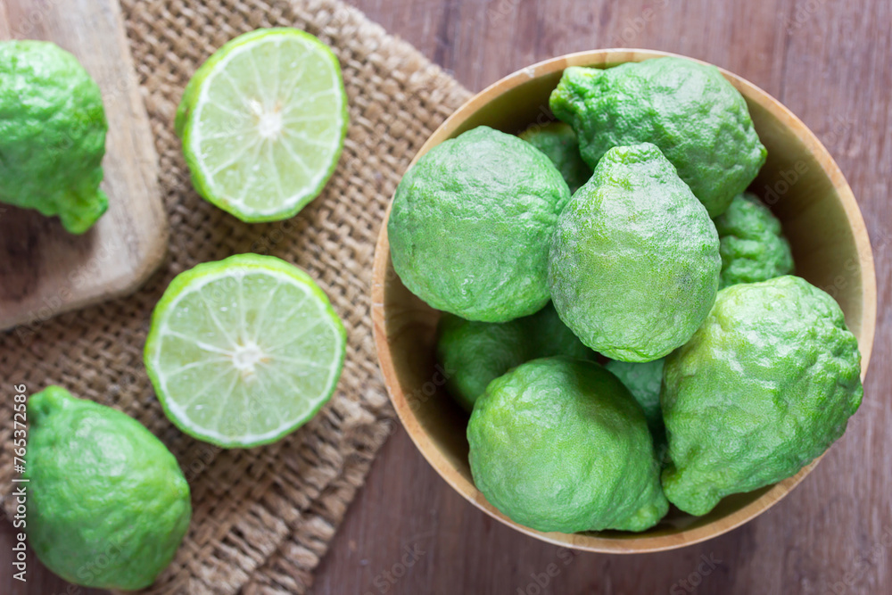 fresh bergamot and bergamot slice in wooden bowl fresh bergamot and bergamot slice in wooden bowl