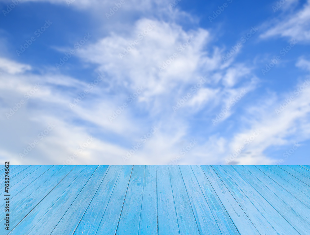 Blue wooden table with sky background