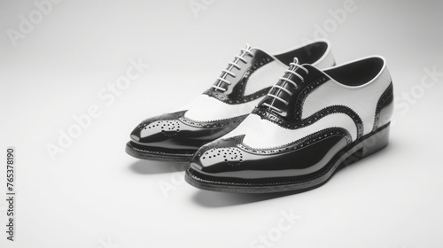 pair of vintage saddle shoes in classic black and white, with retro wingtip details and a nostalgic charm against a minimalist white backdrop.