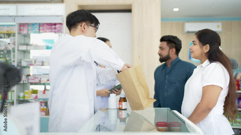 4K Medical pharmacy and healthcare providers concept. Asian man and woman pharmacist recommendation and selling medical product, medicine, drugs and supplements to patient customer at drugstore. 4K Medical pharmacy and healthcare providers concept. Asian man and woman pharmacist recommendation and selling medical product, medicine, drugs and supplements to patient customer at drugstore.