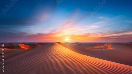  Against the background of desert horizons illuminated by the colors of sunset  golden sand dunes look like a work of art in which every grain of sand emphasizes the beauty