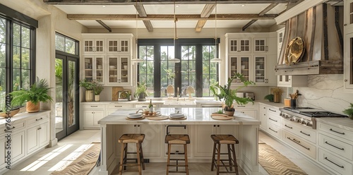 Kitchen with white cabinets, stools, large island, lots of windows