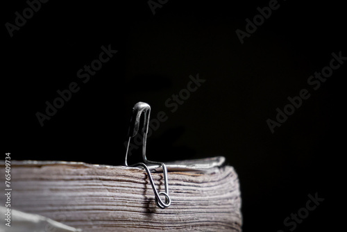 Fotografie Two safety pins that look like a couple of lovers are sitting and talking