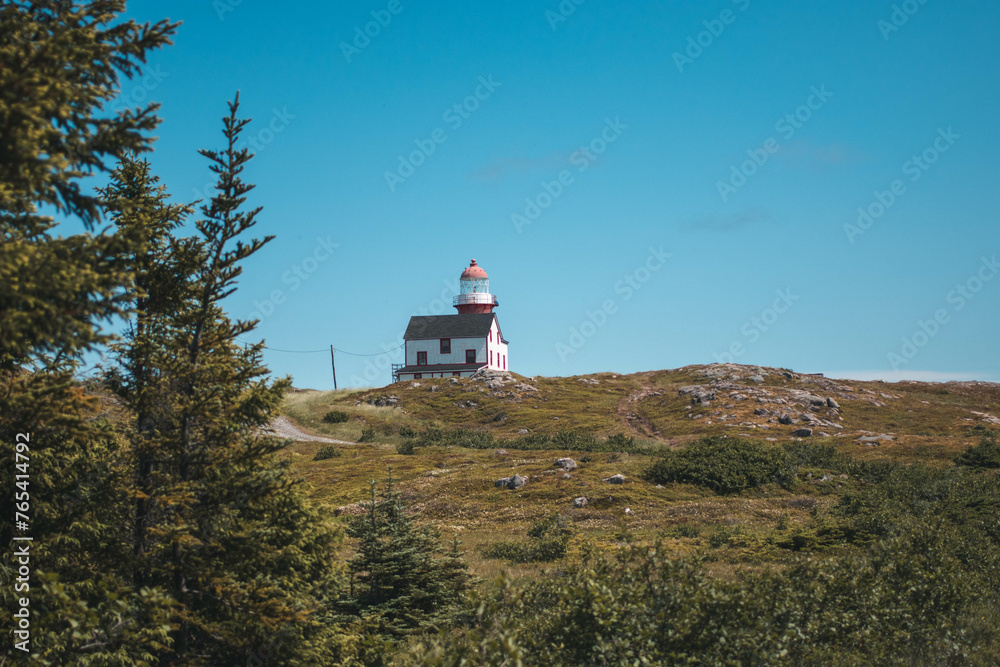 Ferryland lighthouse in the distance with a clear blue sky