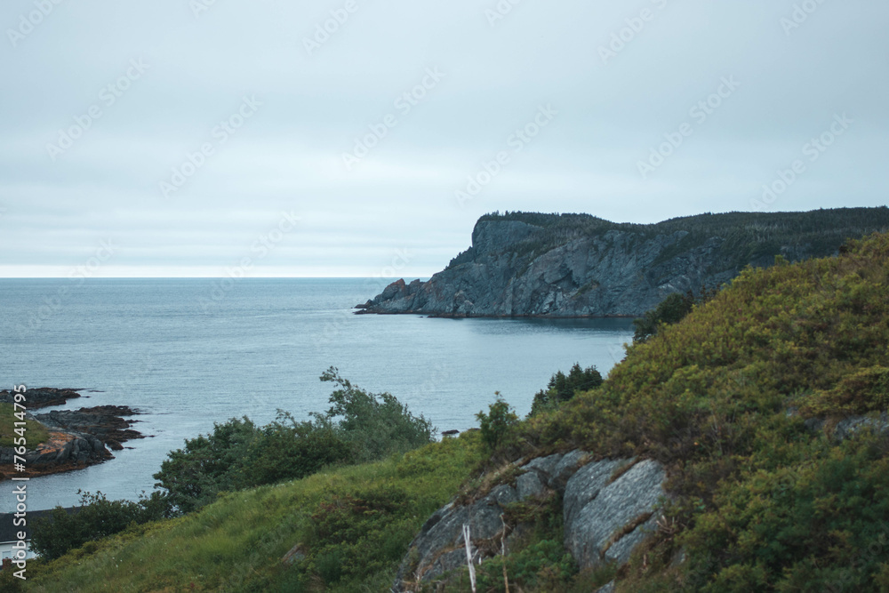 Brigus Head coastline on a cloudy day with calm ocean water
