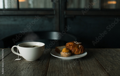 Swedish fika, cakes on a table with a steaming hot cup of herbal tea