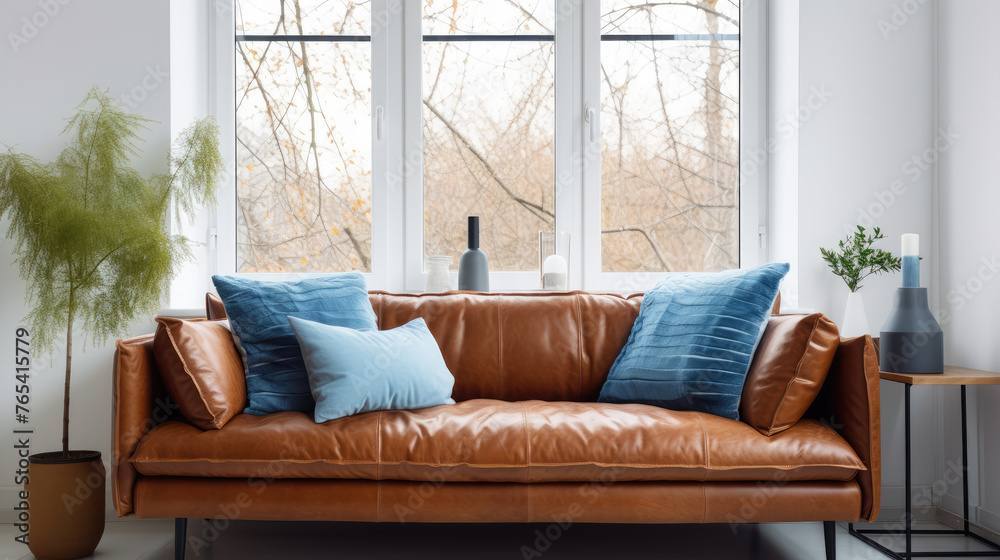 Fototapeta premium Brown shaggy leather sofa with blue pillows near window. Scandinavian home interior design of modern living room Generative AI