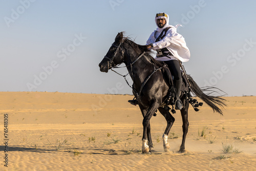 Arabian horseback archer riding his stallion in the middle of sand dunes