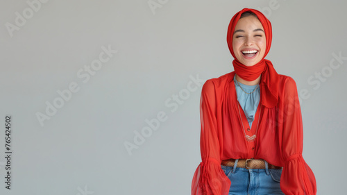 Arab woman wearing red shirt smiling laugh out loud isolated on grey