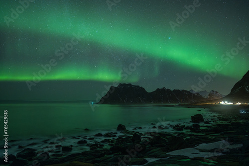 The Aurora borealis with uttakleiv beach and a lot of star in the sky 