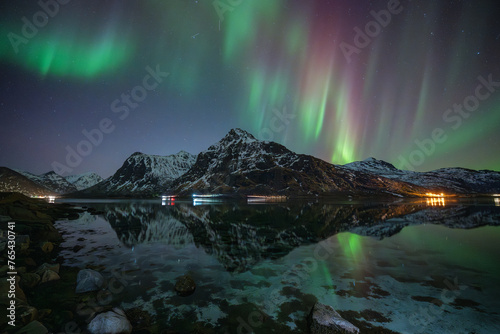The great of. mountain with a colorful northern light with reflection on Lofoten ,Norway 