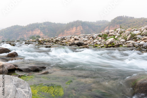 Long exposure of the flowing Kosi river in Jim Corbett, Uttarakhand, India. photo