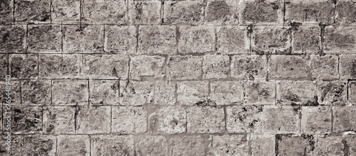 Stone Wall Weathered Obsolete Monochrome Texture. Aged Brickwork. Distressed grunge Surface. Background Backdrop Banner. Black and white