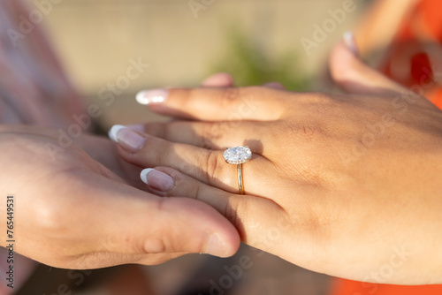 Engagement ring on finger © Kadeem