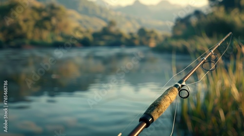 Fishing rod poised by the riverside with a beautiful and cool river background, offering a peaceful retreat and an opportunity for outdoor adventure in nature's playground. 