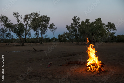 Campfire burning in dry outback landscape near Boulia in Queensland, Australia