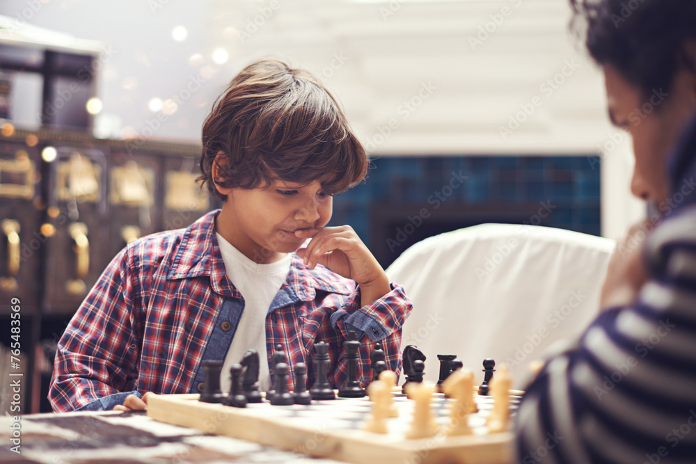 Child, father and chess game with thinking strategy or checkmate move with knight, king or queen. Son, parent and board for competition learn or decision thoughts for play, contest or problem solving