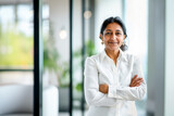 Indian business woman. Mature elder lady in corporate office. Professional executive manager, entrepreneur or CEO. Old senior businesswoman in portrait. Happy smiling confident employer or lawyer.