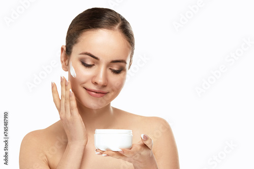Skin care. Beautiful Pretty Woman Holding and Applying Cosmetic Cream. Girl with fresh skin. Spa. Beauty Concept. Female with fresh makeup and Perfect Skin.