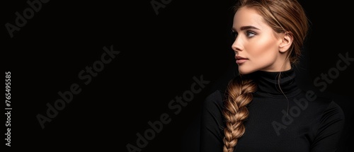  A woman wearing a black turtleneck, long hair in a fishtail braid, and turned her head away from the camera