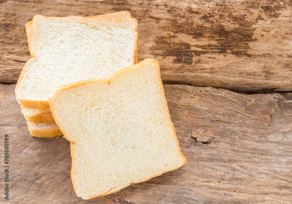 Slice of bread on wooden table background
