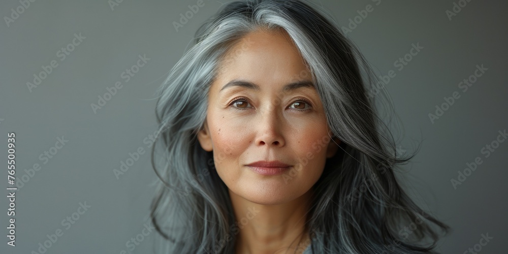 In a confident and elegant portrait, a stylish retired grandmother radiates timeless beauty.