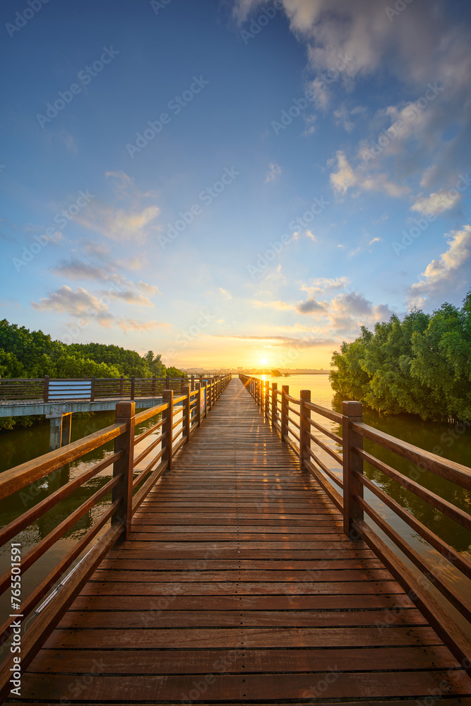 Fototapeta premium Sunrise on Mangrove Plank Road in Shuidong Bay, Maoming, Guangdong