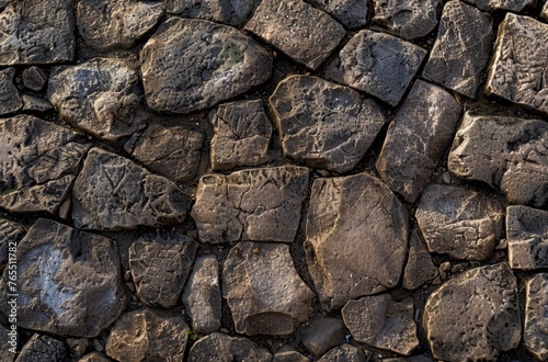 Detailed view of a wall constructed entirely of rocks, showcasing their textures, shapes, and arrangement