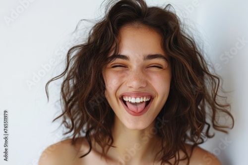 Young happy brunette woman is winking and showing tongue on a white background, Generative AI photo