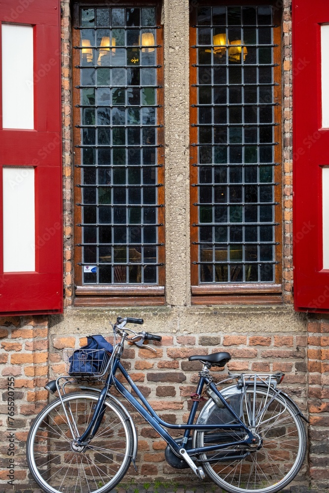 medieval house facade with windows and bicycle