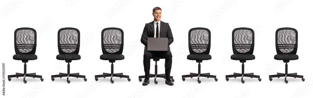 Businessman with a laptop computer sitting in an office chair between empty chairs Businessman with a laptop computer sitting in an office chair between empty chairs