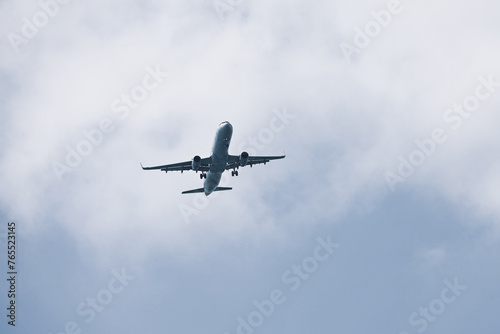 Airplane flying in sky with clouds. Passenger plane at flight, travel concept