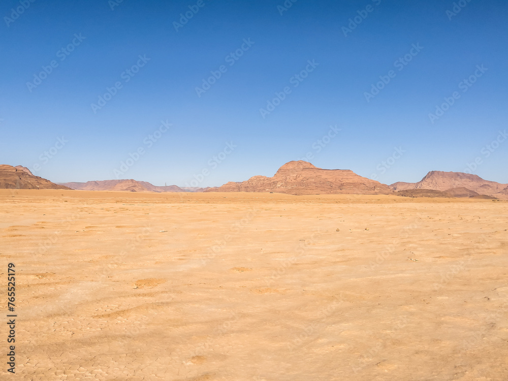 Wadi Rum Desert In Jordan. Yellow and Orange Desert Sand under the Blue Sky Wadi Rum Desert In Jordan. Yellow and Orange Desert Sand under the Blue Sky