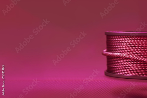bobine de cuivre, de galon rose vif de passementerie,  de cordelette, sur fond rose vif avec espace négatif copy space