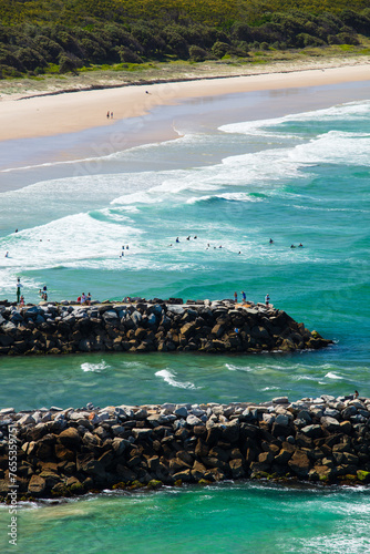 Swimmers and people spending time around the surf beach and mouth of the Evans River of Evans Head.
