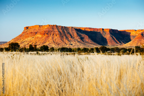 Sunset colours on the rising landforms above the plains near Kings Canyon in Central Australia photo