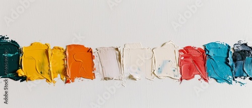  A palette of various hues of paint arranged on a white background adjacent to one another