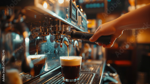 A person pouring a coffee into a glass at a bar or coffeehouse.