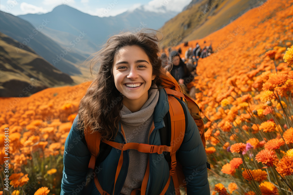 Smiling Woman Traveler in Colorful Flower Field with Majestic Mountain Background