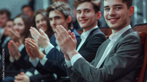 Selective focus of A group of businessmen clapping in a seminar room.